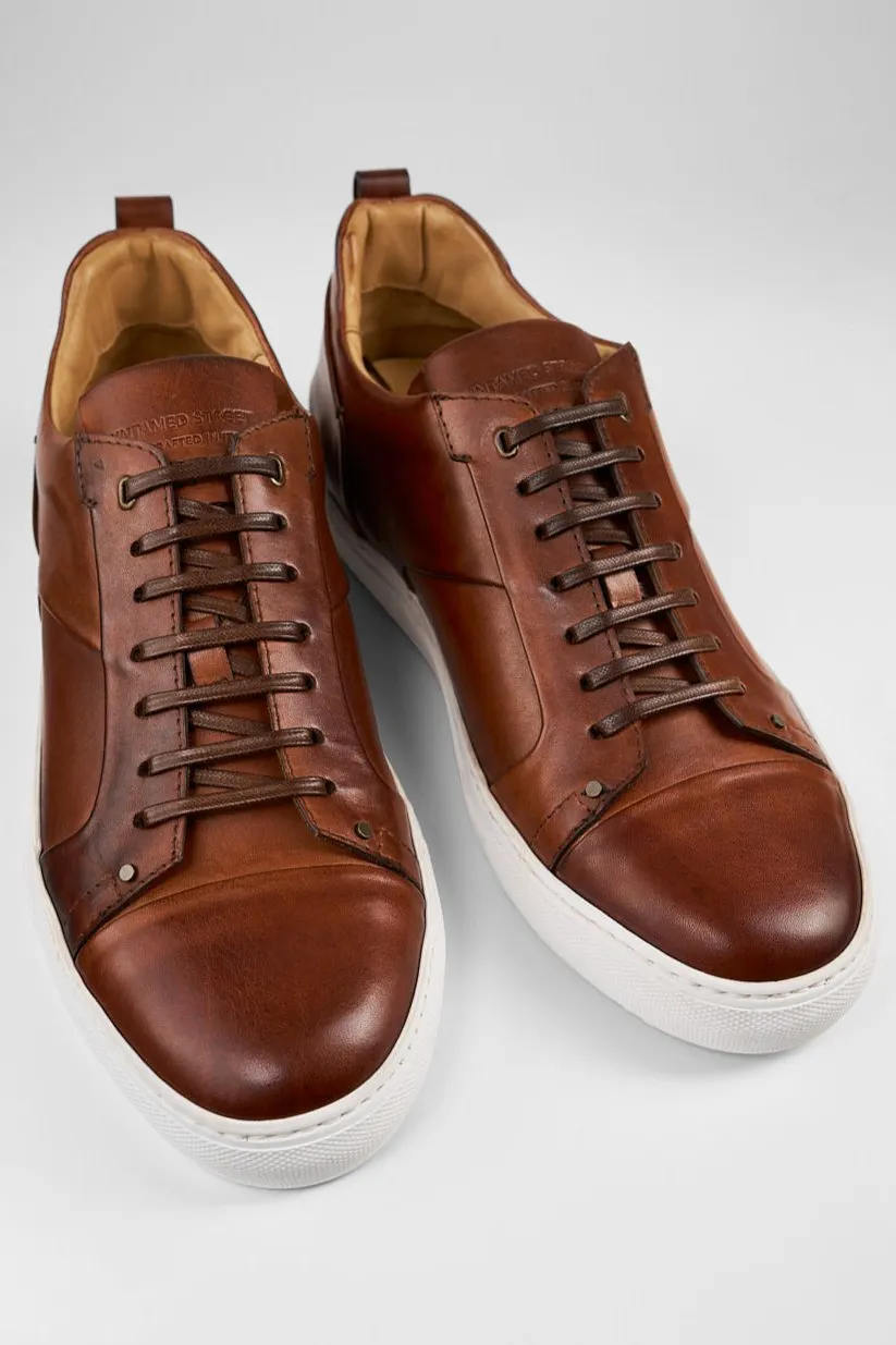 SKYE cognac studded patina sneakers.
